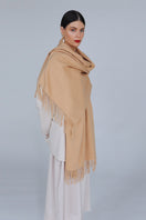 Aethera Helena cashmere shawl in camel draped gracefully, showcasing soft, luxurious cashmere fabric and elegant design.