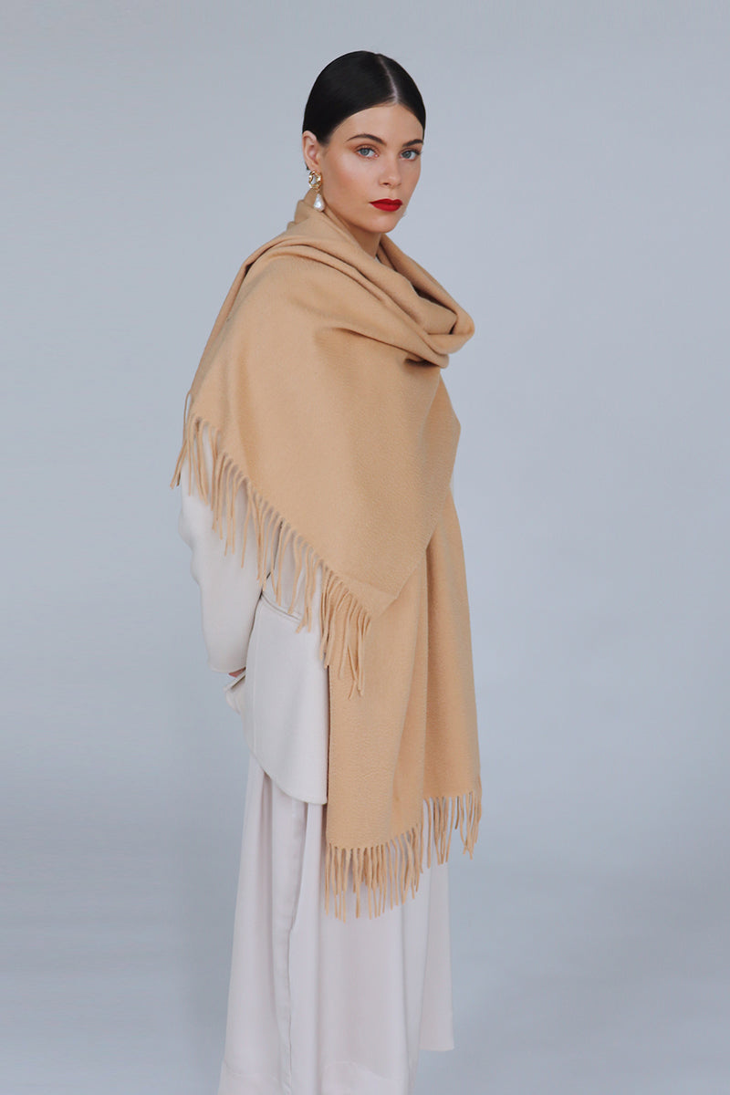 Aethera Helena cashmere shawl in camel draped gracefully, showcasing soft, luxurious cashmere fabric and elegant design.