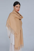 Aethera Helena cashmere shawl in camel, draped elegantly to showcase its soft texture and stylish design.
