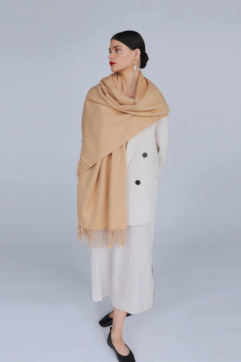 Aethera Helena cashmere shawl in camel draped elegantly, showcasing its soft texture and stylish design.