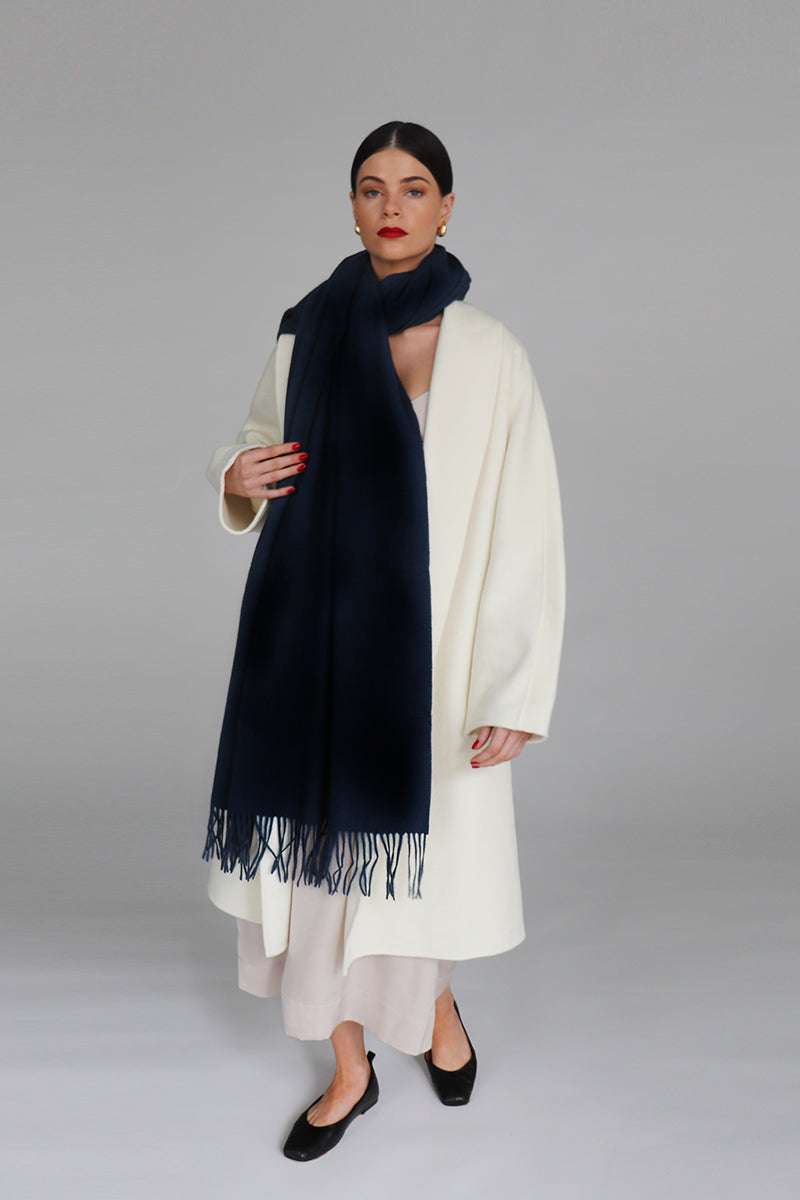 Navy Aethera Serene lambswool shawl draped elegantly, showcasing soft texture and cozy warmth.
