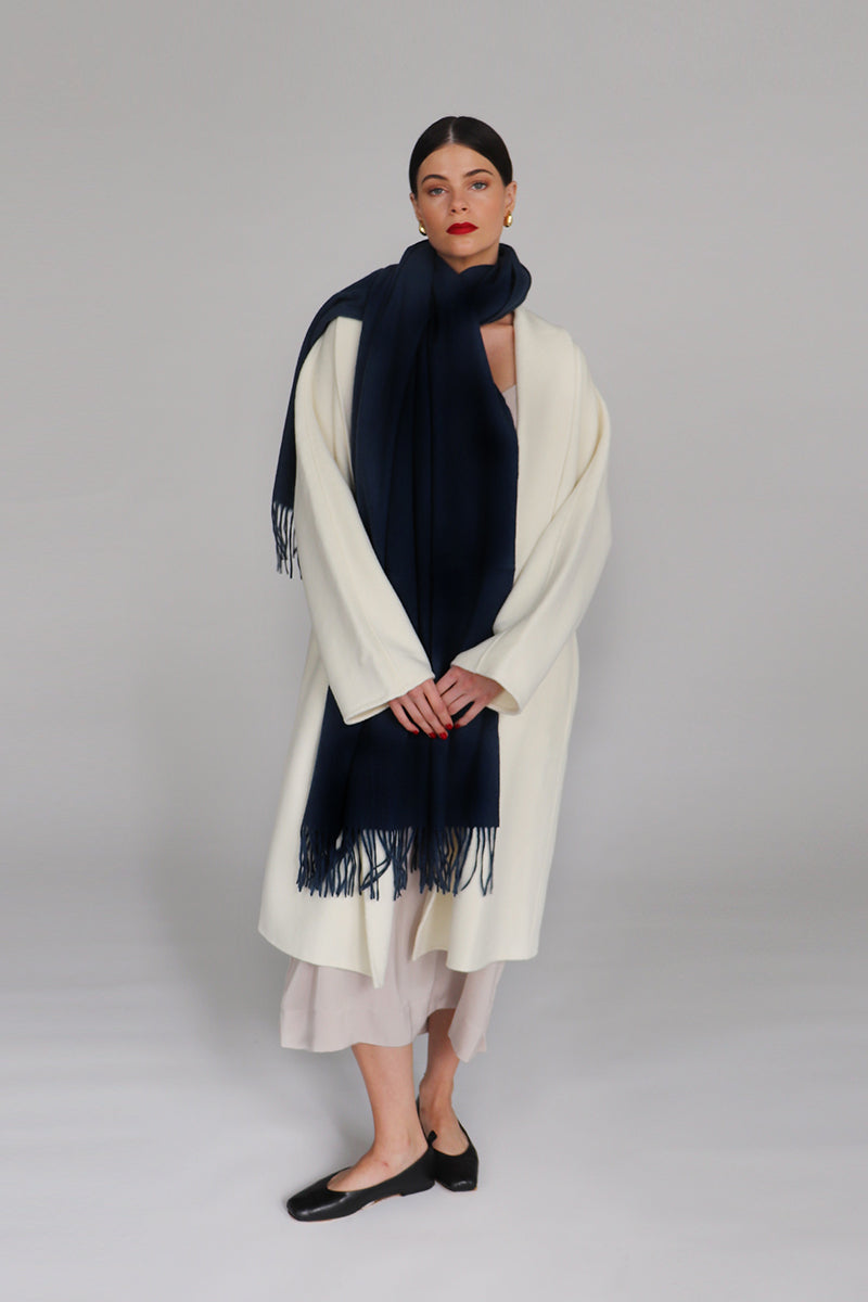 Navy Aethera Serene Lambswool Shawl draped over a mannequin, showcasing soft, cozy wool fabric and elegant design in a scarf and shawls image.