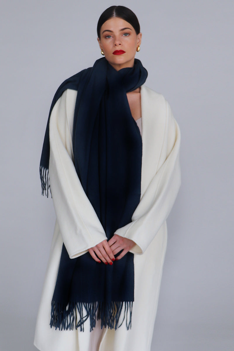 A navy Aethera Serene lambswool shawl draped elegantly, showcasing soft, warm wool fabric perfect for scarves and shawls.