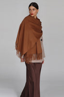 Aethera Helena cashmere shawl in birch color, draped elegantly showcasing soft, luxurious fabric and stylish design.