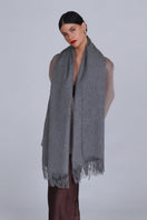 Aethera Helena cashmere shawl in steel color, showcasing soft, luxurious fabric draped elegantly.