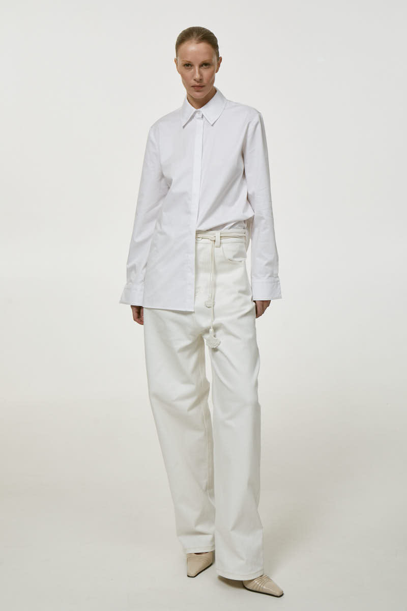 White embroidered shirt by DELEGAN, featuring detailed embroidery on soft fabric, perfect for casual or semi-formal wear.