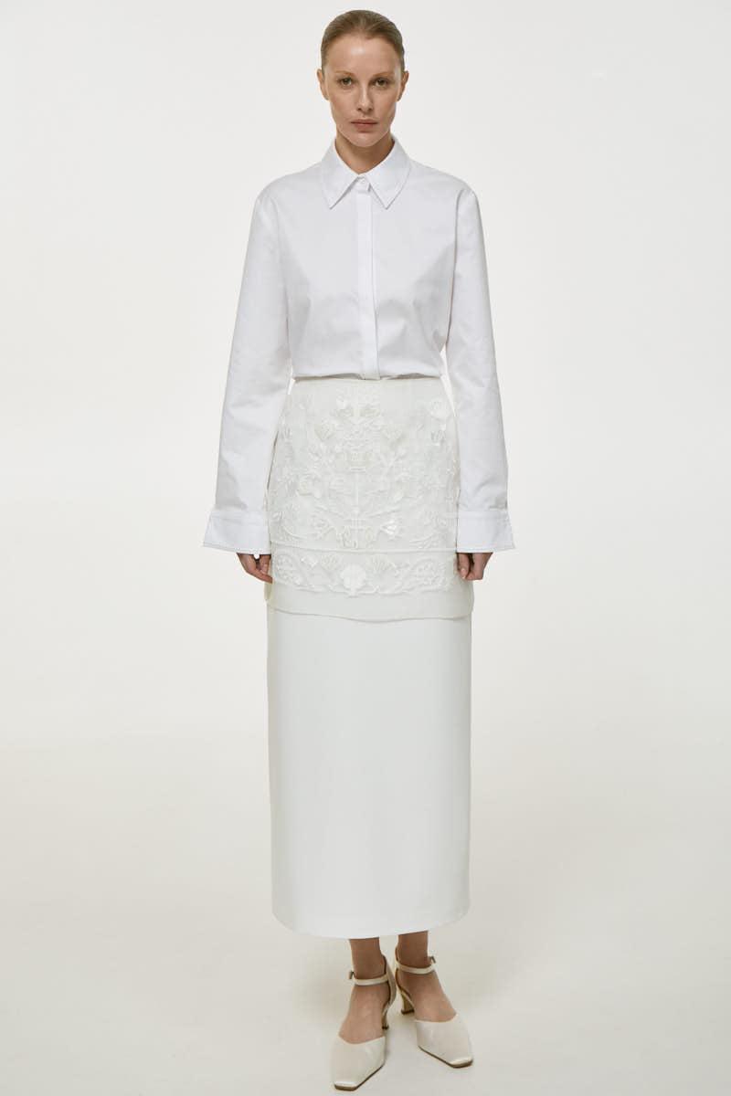 DELEGAN Naked Plakhta midi skirt in soft fabric, featuring a sleek, modern design perfect for stylish everyday wear.