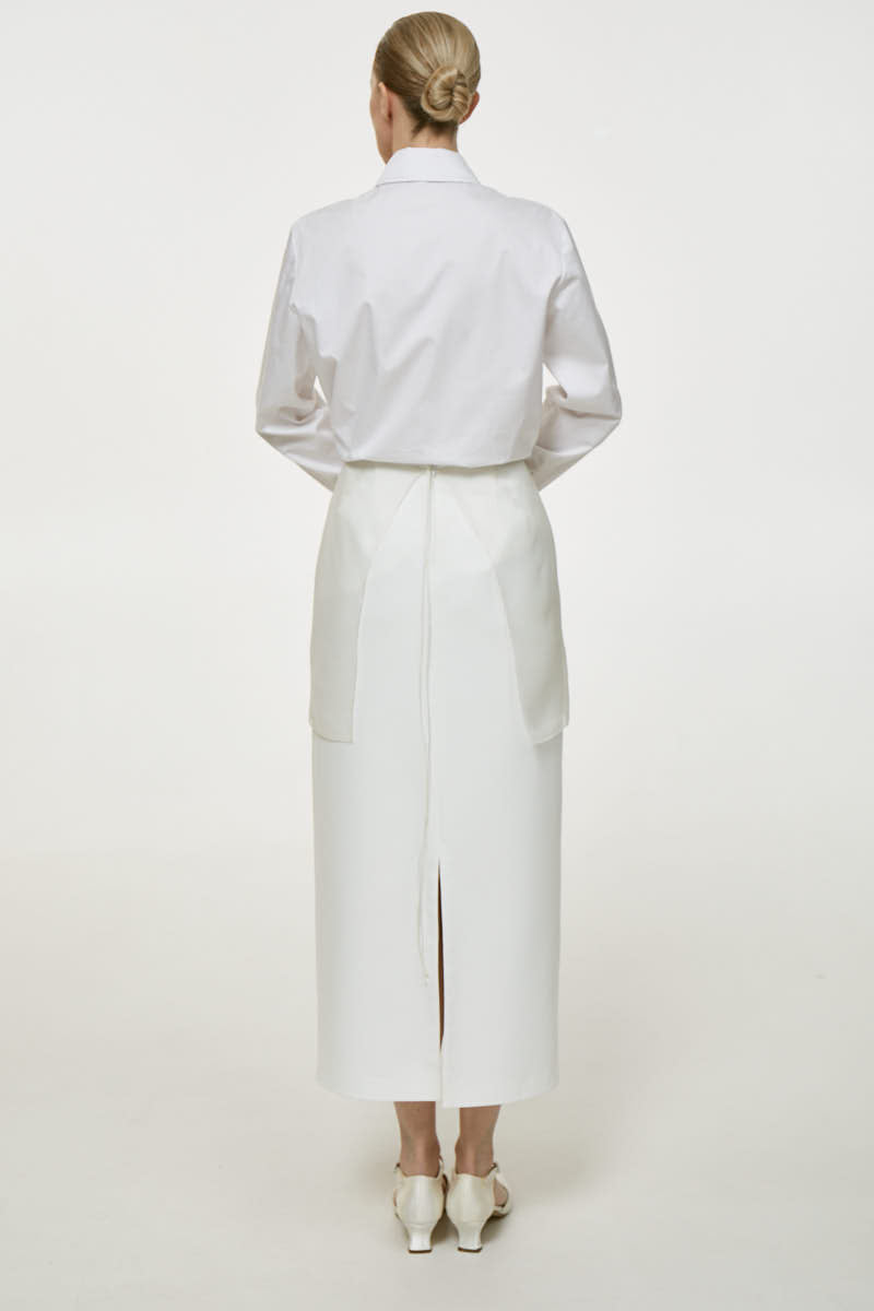 DELEGAN Naked Plakhta midi skirt in neutral fabric, featuring a high waist and flowing midi length for a stylish, versatile look.
