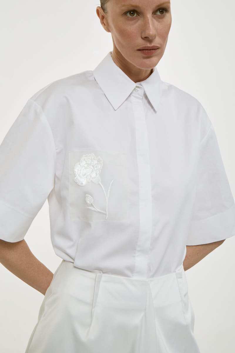 BlueDottle shirt by Delegan, showcasing a casual long-sleeve shirt with a button-up front and collar, displayed on a hanger.