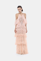 Peach ruffled halter gown by Montsand featuring a flowing design and elegant ruffle details, perfect for formal occasions.