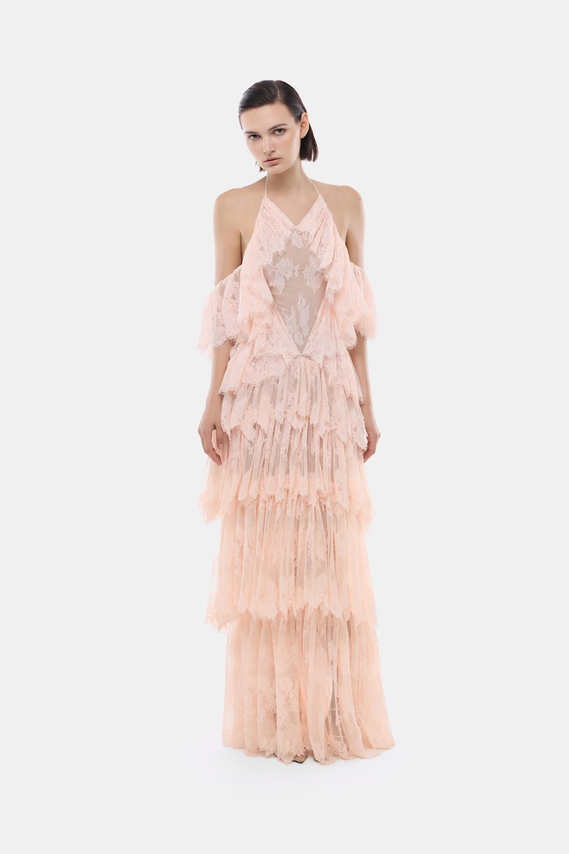 Peach ruffled halter gown by Montsand featuring a flowing design and elegant ruffle details, perfect for formal occasions.