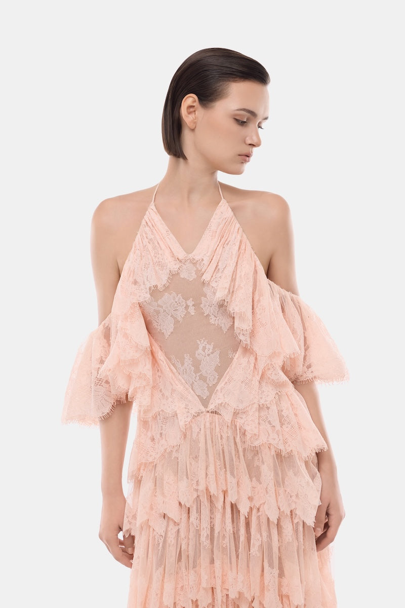 Montsand peach ruffled halter gown with flowing fabric and elegant design, perfect for formal occasions.
