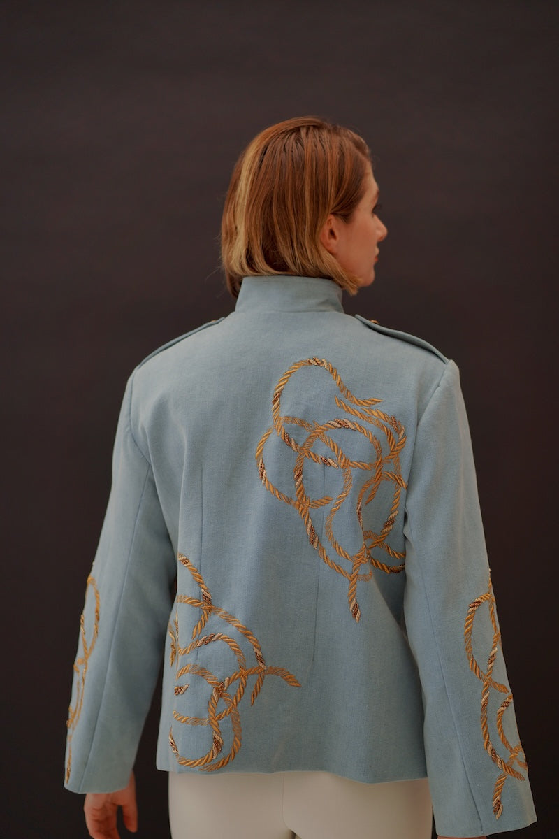 Nadya Shah Daley Denim Cargo Jacket with multiple pockets, classic blue denim, and button closures on a hanger.