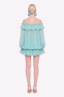 Turquoise Valenciani off-shoulder mini dress styled as a scarf, shown from the back with flowing fabric and elegant drape.