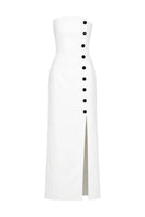 Izakova Dariana off-white maxi dress displayed on a hanger with flowing fabric and elegant design.