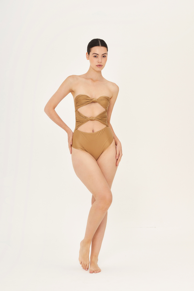 Aguaclara DUNE one-piece swimsuit in vibrant colors, featuring a stylish cut and supportive fit, displayed on a mannequin.