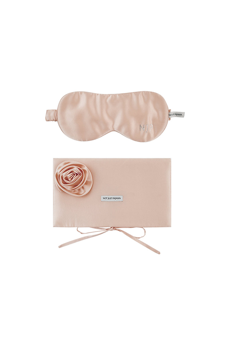 Pink silk eye mask and matching pouch set from Not Just Pajama, soft and luxurious for home comfort and relaxation.