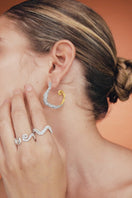 Jude Benhalim ELEA HOOPS MIX earrings shown on a model, featuring stylish hoop designs in various sizes and finishes.