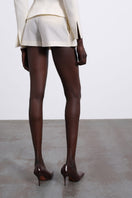 SÉLONE ELEN double layer white shorts with panel design, front view showcasing relaxed fit and stylish casual style.