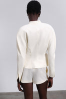 Cream SÉLONE ELEN SCULPT blazer displayed on a hanger, showcasing tailored fit and structured design.