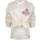 Estefania honey rose blouse, stylish shirt with floral design and soft fabric, displayed on a hanger.
