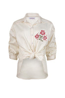 Estefania honey rose blouse, stylish shirt with floral design and soft fabric, displayed on a hanger.