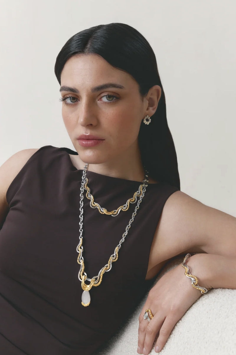 Elegant Jude Benhalim eternity necklace with a continuous loop of sparkling silver or gold, showcasing intricate design details.
