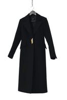 Black Kris Marán straight cut coat with signature buttons, showcasing a tailored design and sleek style in the image.