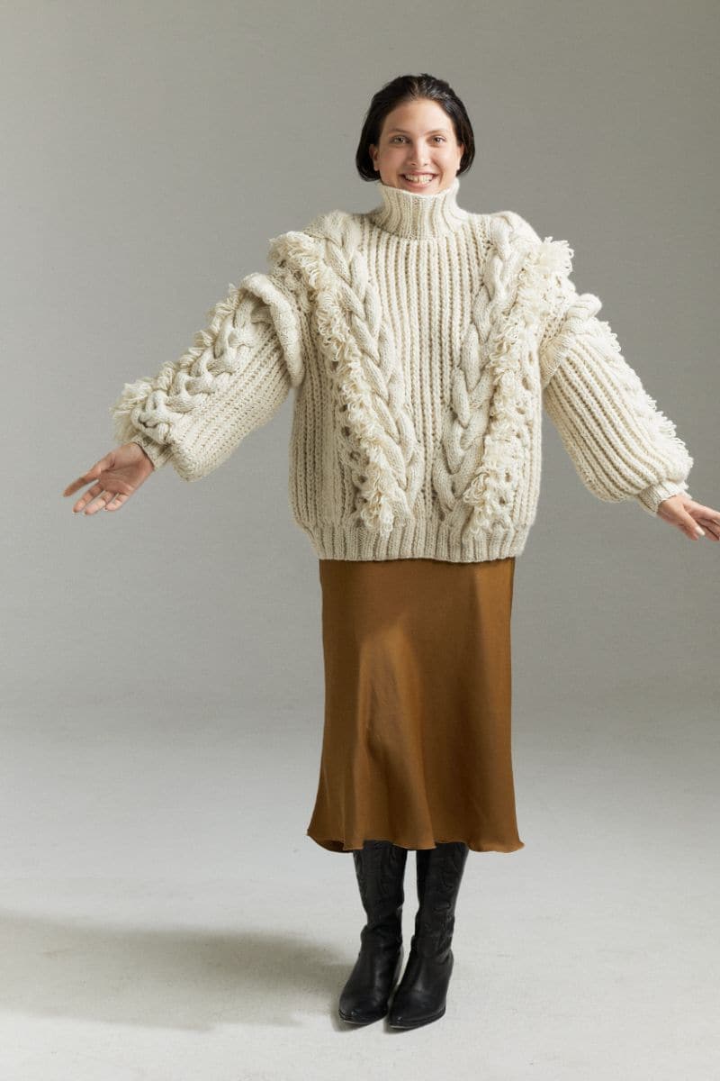 Off-white Anastasia cable turtleneck sweater by First Born Knits, showcasing its cozy knit texture and classic fit.