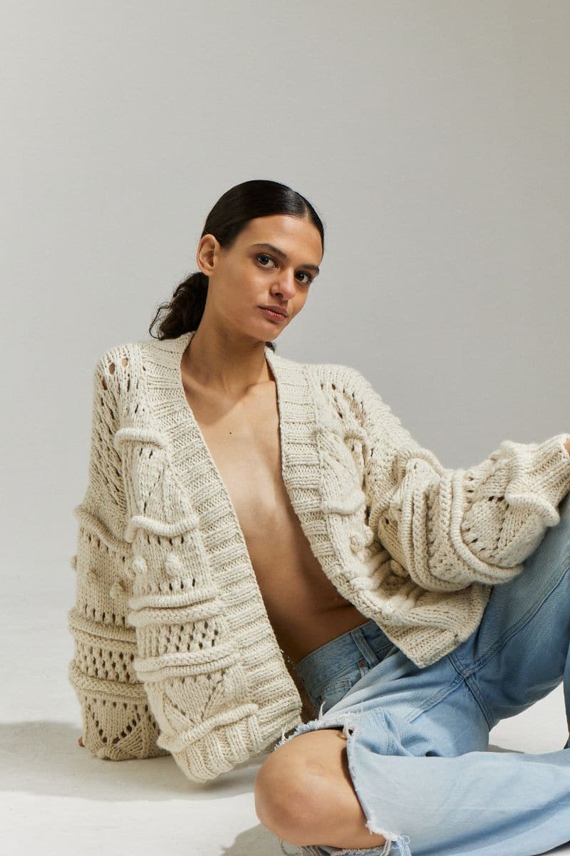 First Born Knits Brigitte Bomber Cardigan in off-white, XS/S, featuring a cozy, stylish design with ribbed cuffs and front pockets.
