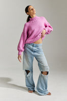 First Born Knits Candy Eve midi turtleneck sweater in candy pink, layered style, showing soft knit texture and fitted silhouette.