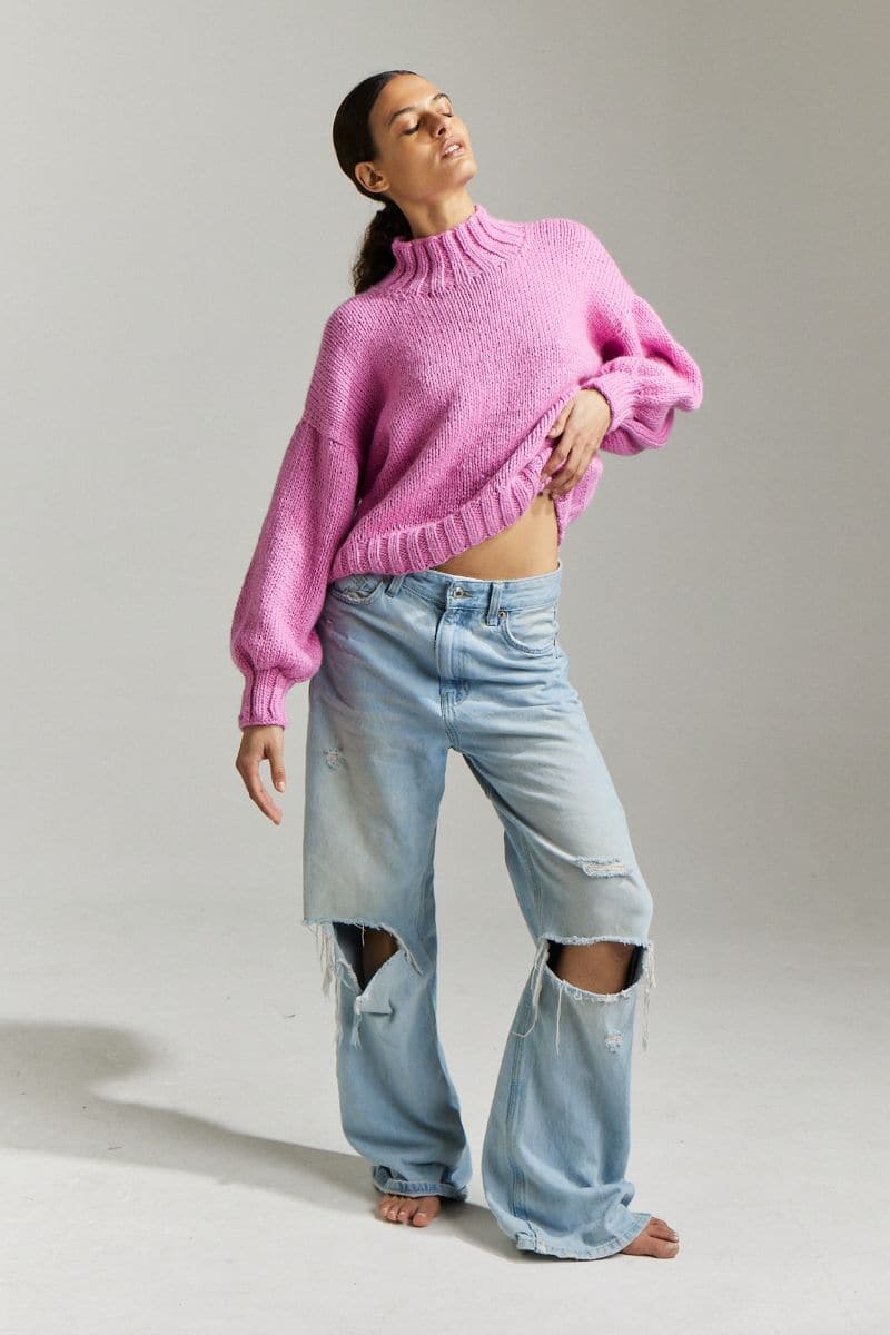 First Born Knits Candy Eve midi turtleneck sweater in candy pink, layered style, showing soft knit texture and fitted silhouette.
