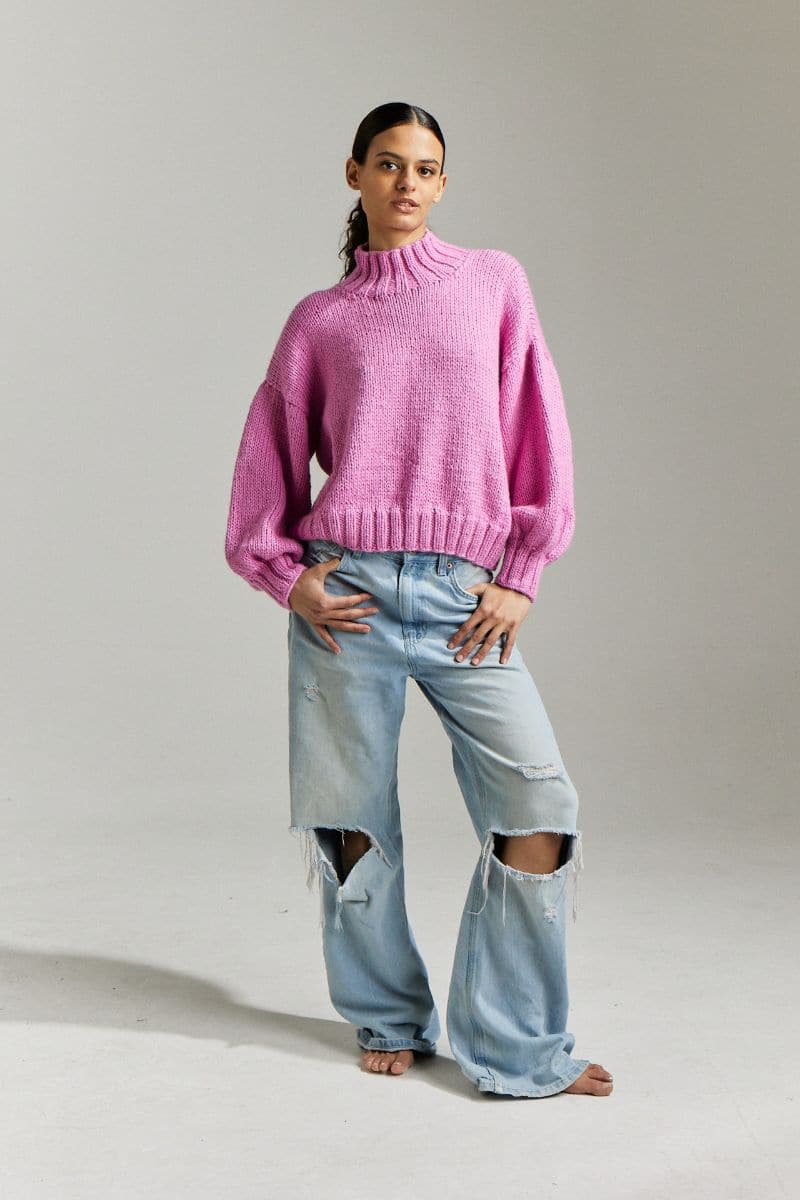 First Born Knits Candy Eve midi turtleneck sweater in candy pink, showing a close-up of the soft, cozy knit fabric.