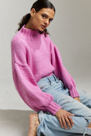 First Born Knits Candy Eve midi turtleneck sweater in candy pink, casual knit with snug turtleneck and fitted silhouette.