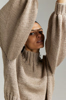 Taupe First Born Knits Evie cropped turtleneck sweater, featuring a cozy knit design and fitted silhouette.