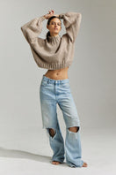 Taupe EVIE cropped turtleneck sweater by First Born Knits, featuring a fitted design and ribbed texture.
