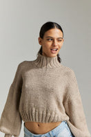 First Born Knits Evie cropped turtleneck sweater in taupe, showing close-up of fitted neckline and soft knit fabric.