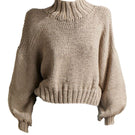 First Born Knits Evie cropped turtleneck sweater in taupe, showcasing a fitted design with ribbed knit texture.