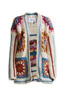 Multicolored First Born Knits Farrah hand-crochet cardigan on a model, showcasing intricate knit pattern and cozy fit.