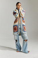 Multicolor first-born knits Farrah hand-crochet cardigan in XS/S, showcasing intricate crochet stitches and vibrant yarn details.