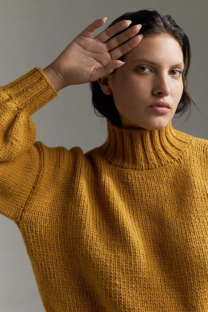 Mustard Eve midi turtleneck sweater by First Born Knits, soft knit fabric, fitted design, model wearing in size small.