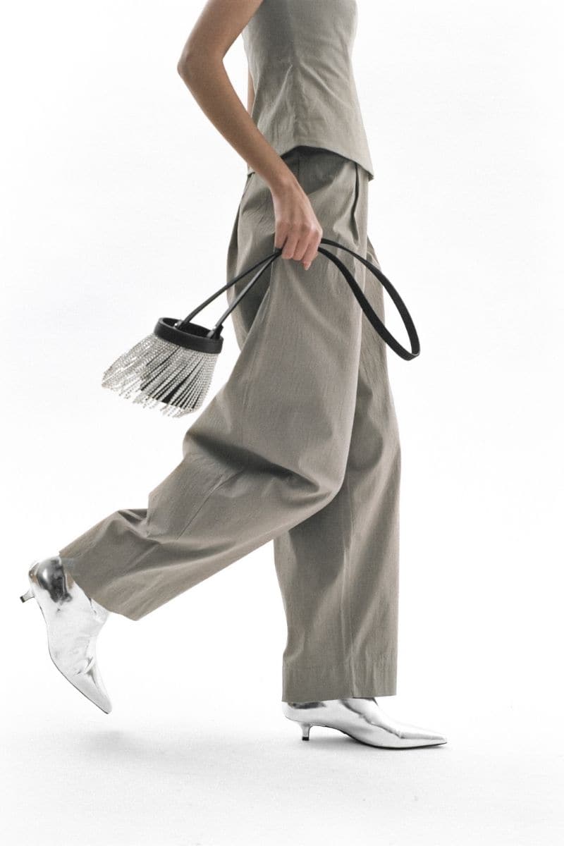 Black fringe mini Kyklos bag from Folklore The Label featuring a top handle and stylish fringe detailing.