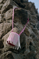 Pink fringe mini Kyklos bag from Folklore The Label, a stylish top handle bag with vibrant fringe details and compact design.
