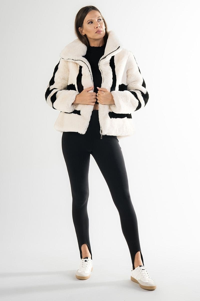 White sporty faux fur jacket by Fortini, featuring a stylish design with black accents, shown on a model.