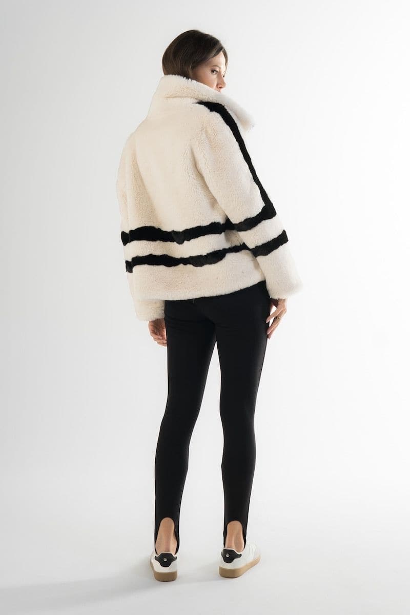 White sporty faux fur jacket by Fortini, featuring a stylish design with black accents, perfect for casual wear.
