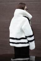 White sporty faux fur jacket by Fortini, featuring a stylish design with black accents, shown on a model in size XS.