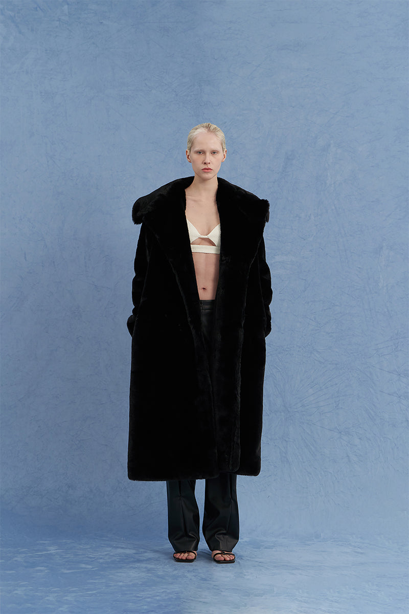 JINSUN oversized black shearling coat displayed from the front, showcasing its plush collar and cozy, stylish design.