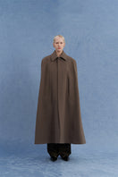 Brown long wool cape coat by JINSUN shown from the front, featuring a classic design and cozy fabric for stylish warmth.