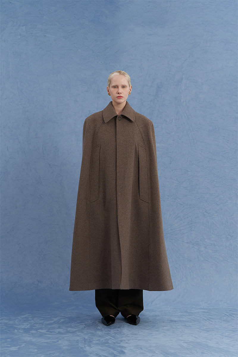 Brown long wool cape coat by JINSUN shown from the front, featuring a classic design and cozy fabric for stylish warmth.