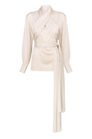 Pearl white wrapped blouse by DELEGAN displayed on a ghost mannequin, front view showing elegant design and fabric details.